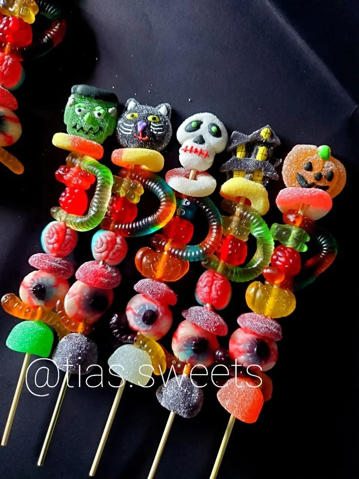 Colorful candy kabobs with various sweets and treats for parties