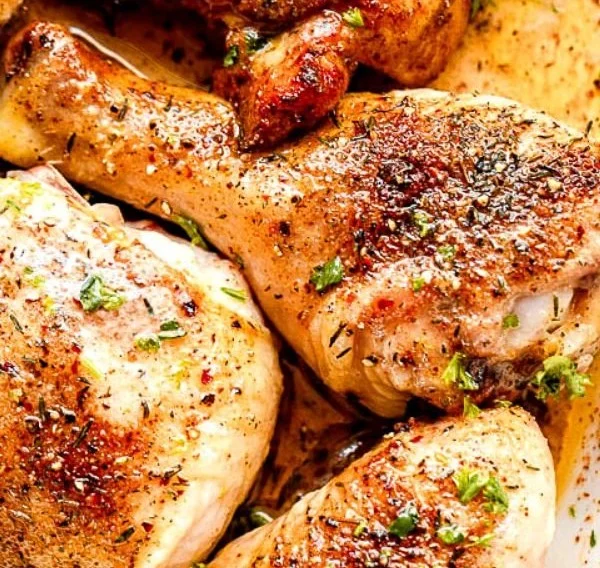 Baked chicken pieces, seasoned and roasted to perfection on a dinner plate.