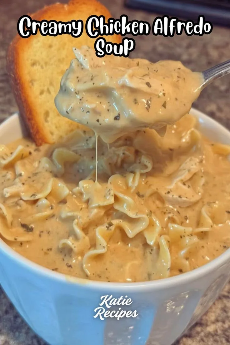 Bowl of creamy Chicken Alfredo Soup garnished with parsley and parmesan cheese.