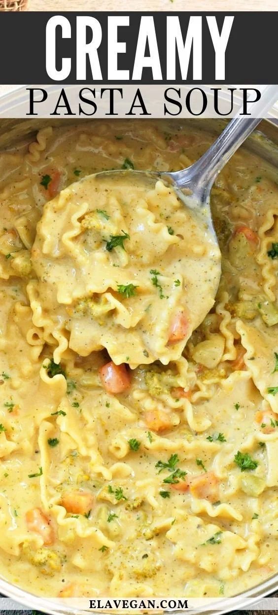 Creamy pasta soup garnished with herbs in a bowl.