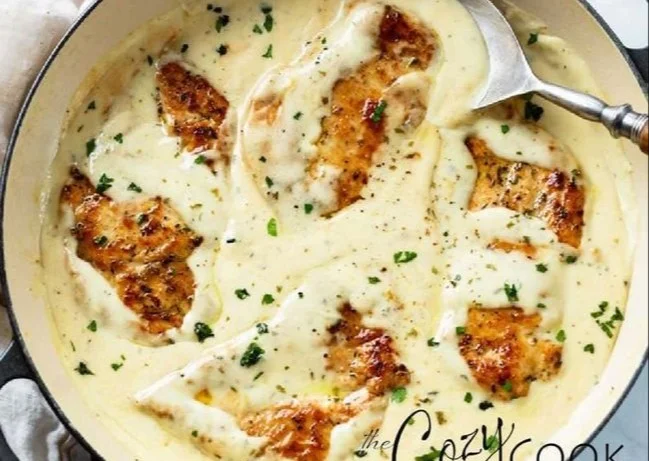 Creamy ranch chicken in a skillet garnished with herbs