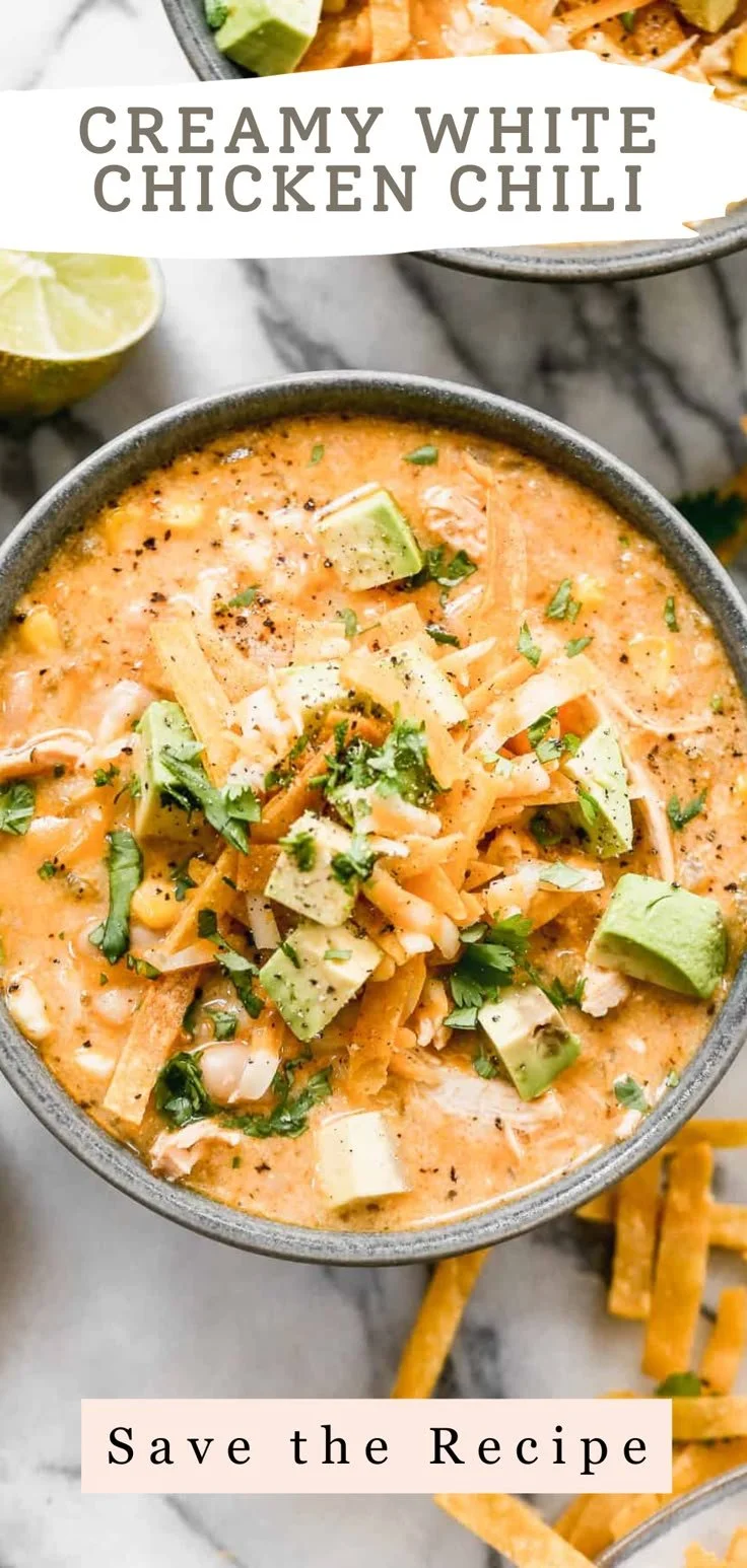 Bowl of creamy white chicken chili topped with cilantro and cheese.
