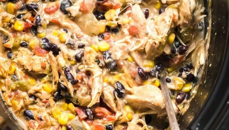 Delicious Crock Pot Fiesta Chicken garnished with fresh vegetables.