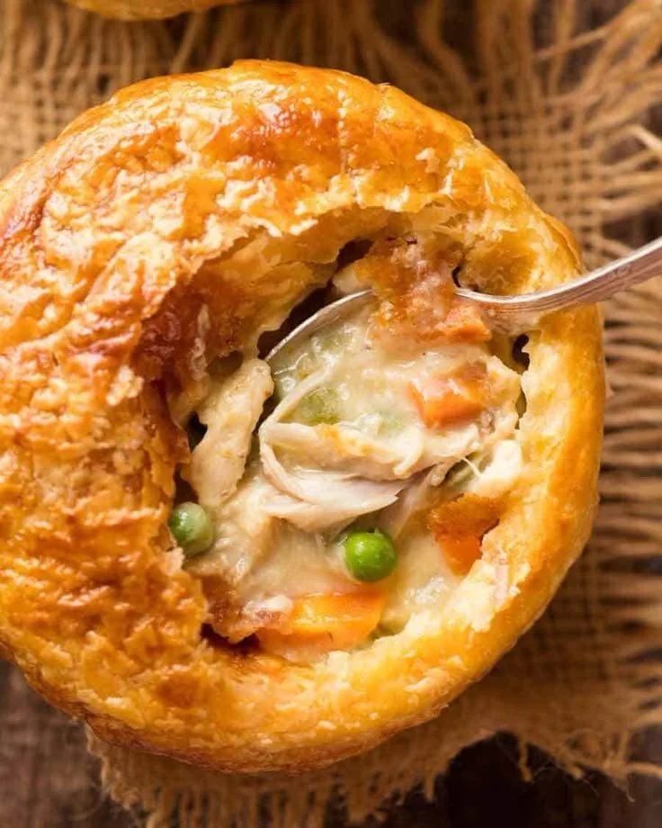 Delicious chicken pot pie with puff pastry topping, perfect for individual servings.