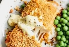 Delicious Chicken Cordon Bleu served on a plate with side vegetables.