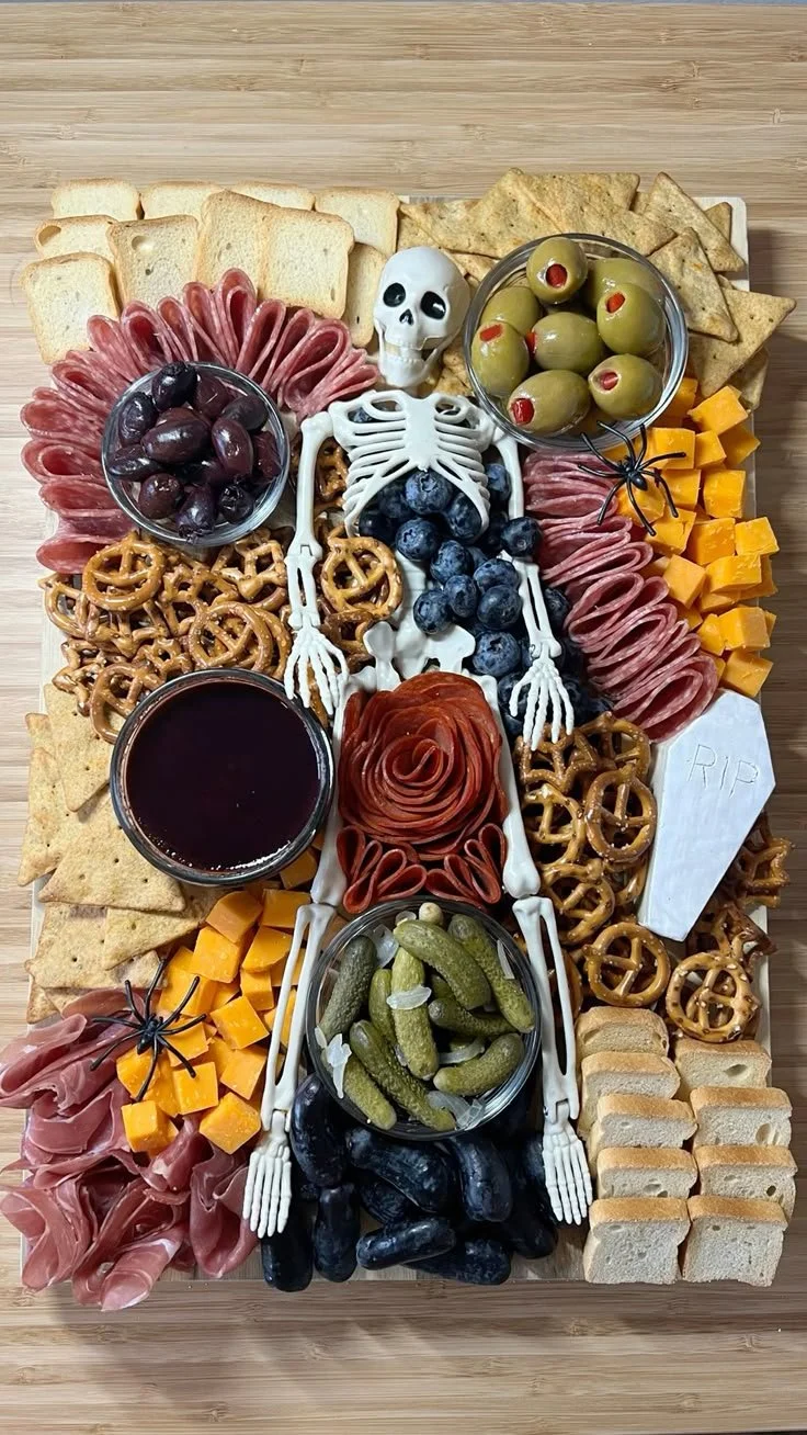 A festive Halloween charcuterie board filled with seasonal treats and spooky decor.