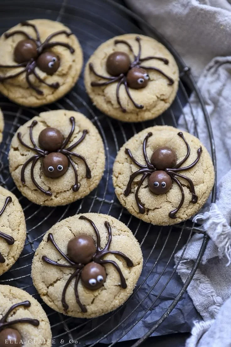 Festively decorated Halloween peanut butter cookies shaped like spiders.