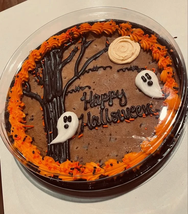 Happy Halloween Cookie Cake decorated with autumn themes and fall colors.