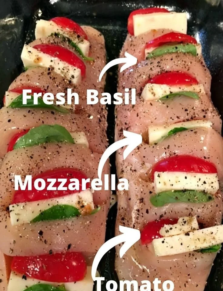 Hasselback Chicken stuffed with cheese, tomatoes, and basil on a plate