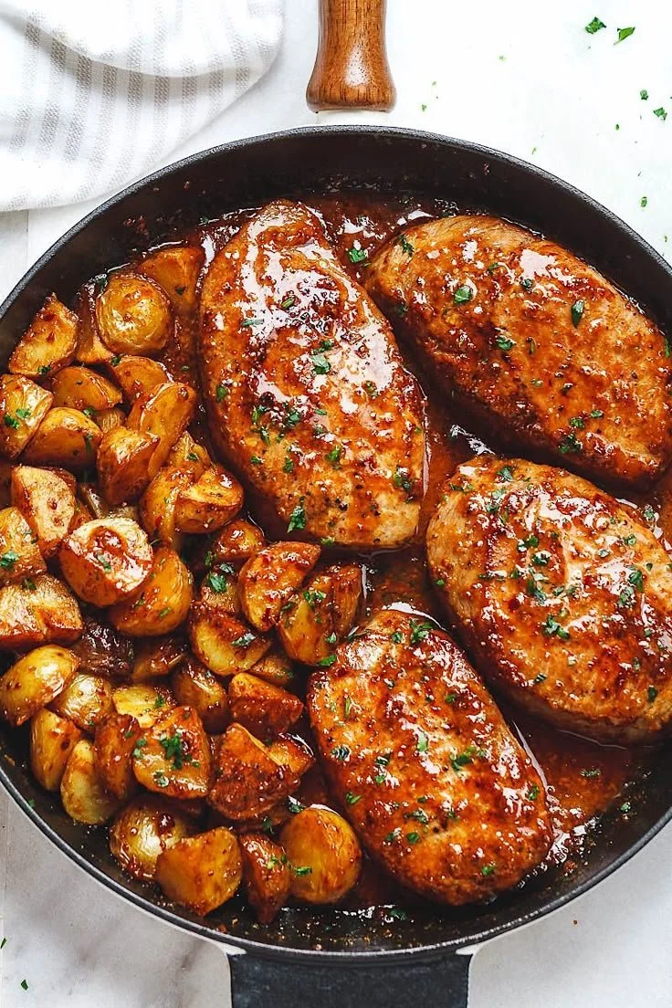 Honey mustard pork chops with potatoes plated elegantly