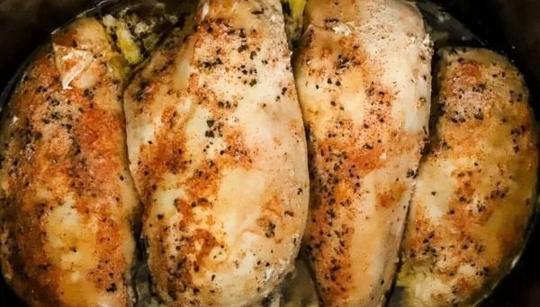 Juicy slow cooker chicken breast served with vegetables on a plate