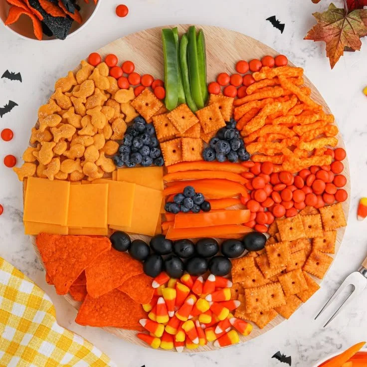Delicious pumpkin charcuterie board with seasonal cheeses, fruits, and decor