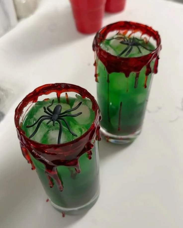 A variety of spooky drinks for Halloween celebrations with eerie decorations.