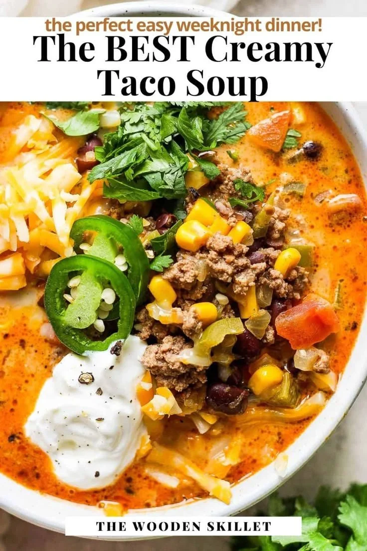Bowl of ultimate creamy taco soup garnished with fresh cilantro and lime.
