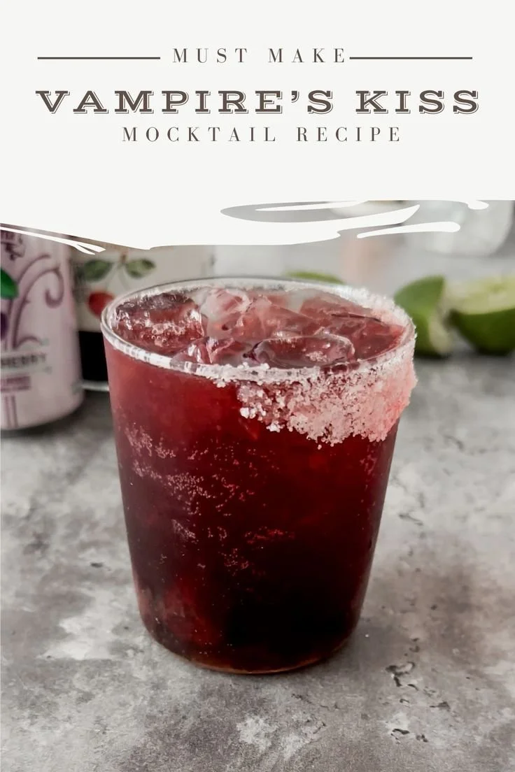 Vampire's Kiss Mocktail garnished with black cherries and served in a spooky glass